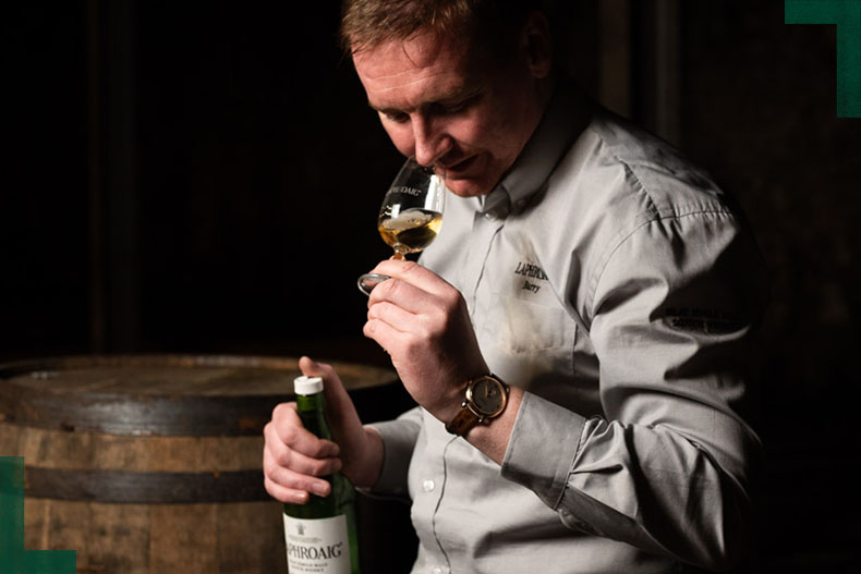 A man nosing a dram of Laphroaig Islay single malt scotch whisky