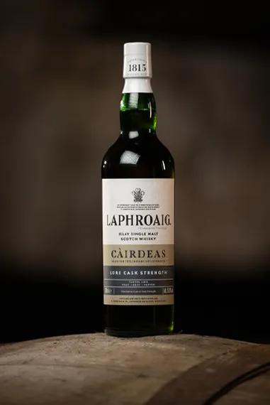 Friends of Laphroaig Cairdeas 2025 bottle on a barrel at distillery 