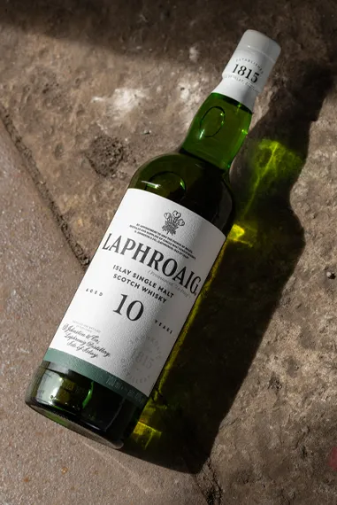 Laphroaig 10 Year Old bottle rolling on distillery floor