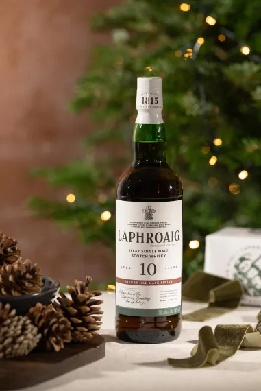 Laphroaig 10 Year Old Sherry Bottle on a festive set table with acorns and a Christmas tree