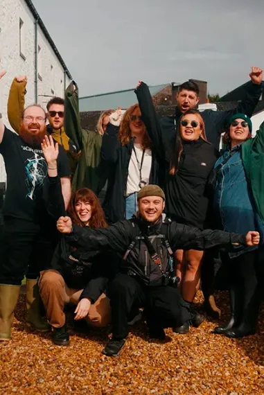 Friends Celebrating Distillery Courtyard Group Visit Laphroaig