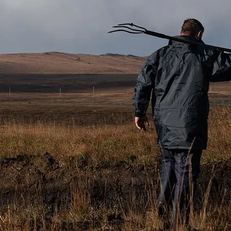 Man with a pitchfork on the isle of Islay whisky