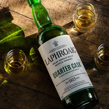 A bottle and three glasses of Laphroaig scotch