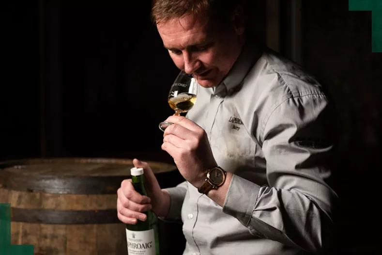 A man nosing a dram of Laphroaig Islay single malt scotch whisky