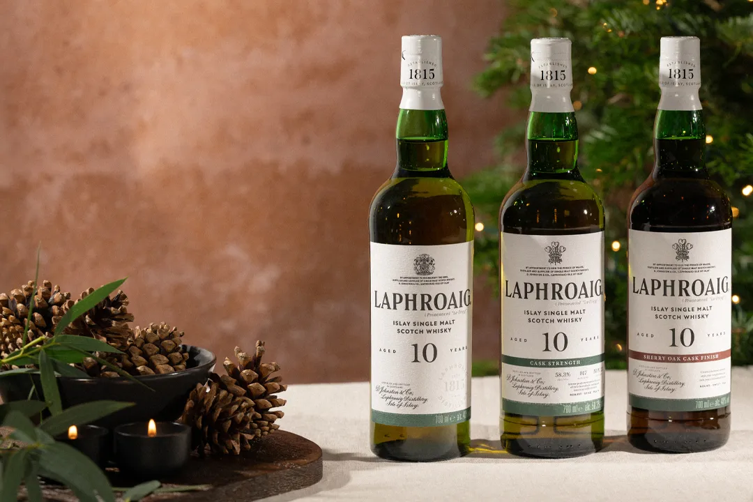 Three bottles of 10 Year Old Laphroaig Core collection on a festive set table