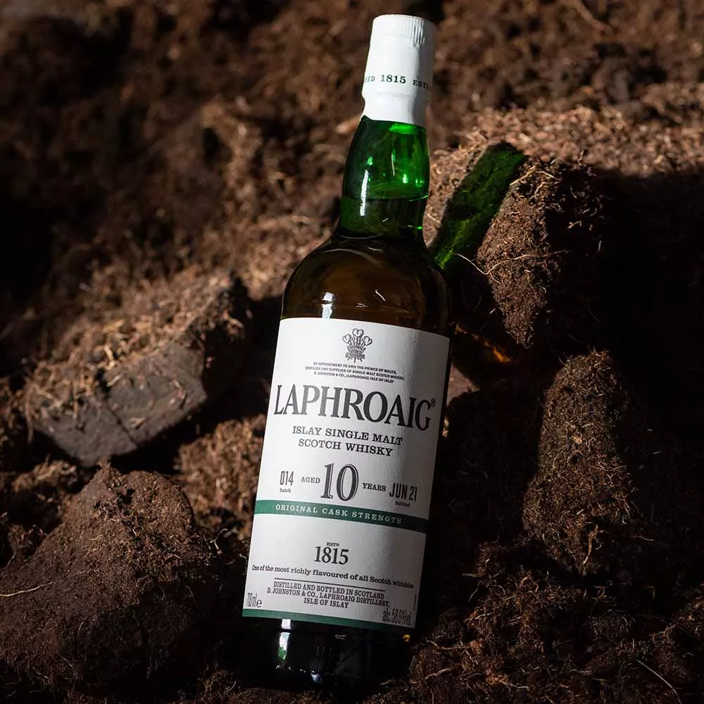 Laphroaig 10 Cask Strength lying on soil