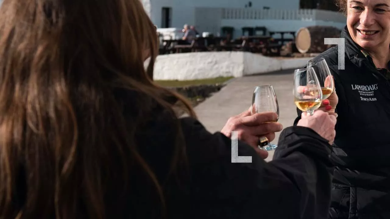 People tasting scotch at the Laphroaig distillery