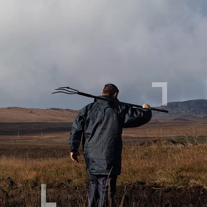 Man with a pitchfork on the isle of Islay scotch