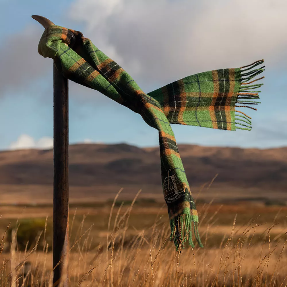 Laphroaig scarf blowing in the wind on a field
