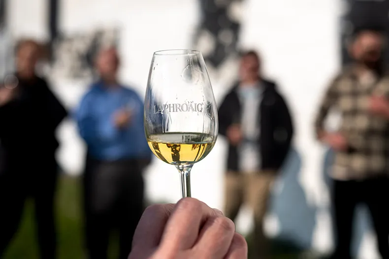 Holding a glass of Laphroaig Cairdeas at the Feis Ile Festival