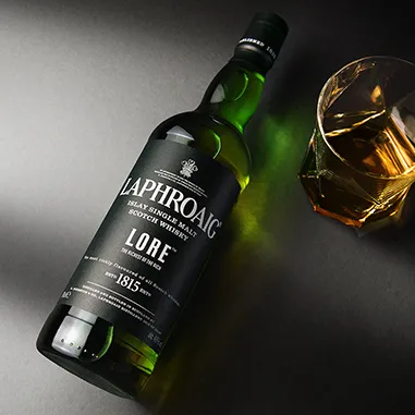 A bottle of Laphroaig Islay single malt scotch whisky on a gray background