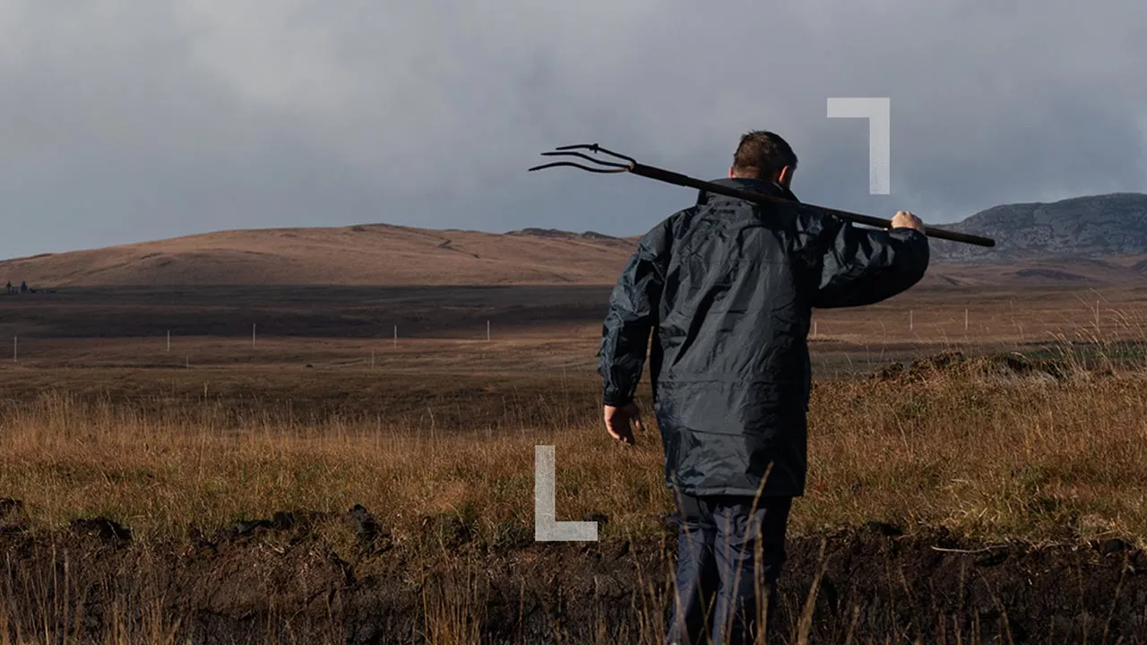 Man with a pitchfork on the isle of Islay scotch