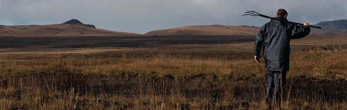 Man with a pitchfork on the isle of Islay whisky