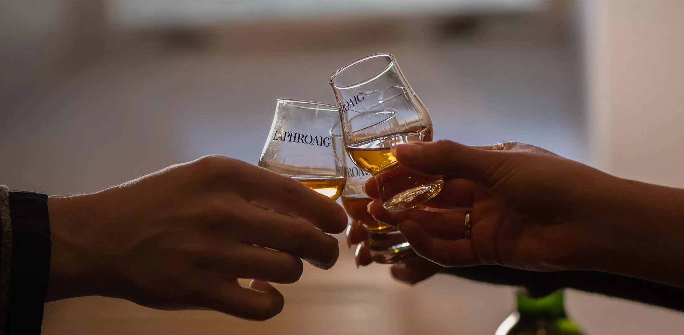 Laphroaig whisky being toasted in dram glass