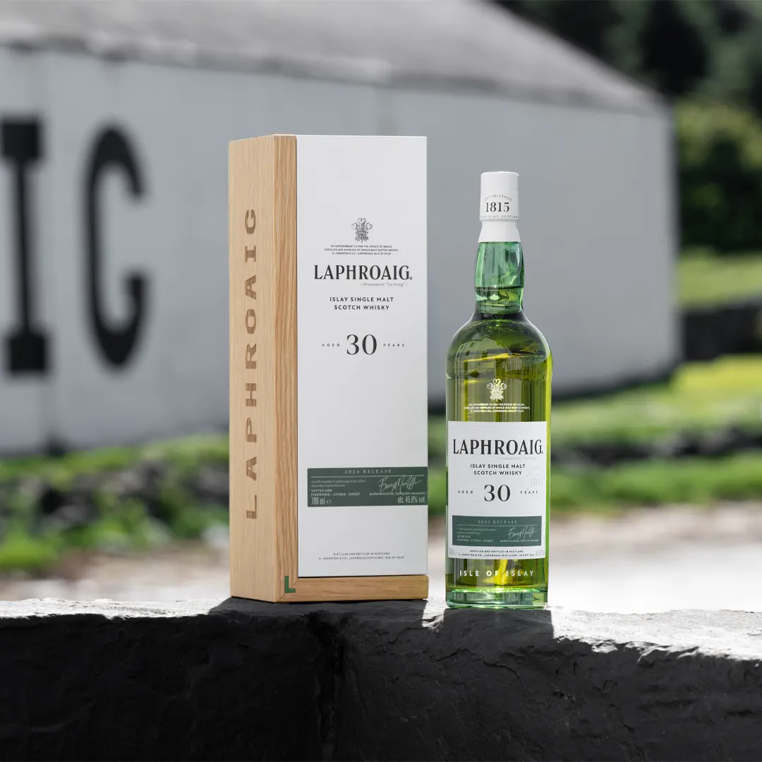 30 Year Old Laphroaig bottle and box on wall in front of Laphroaig Distillery wall