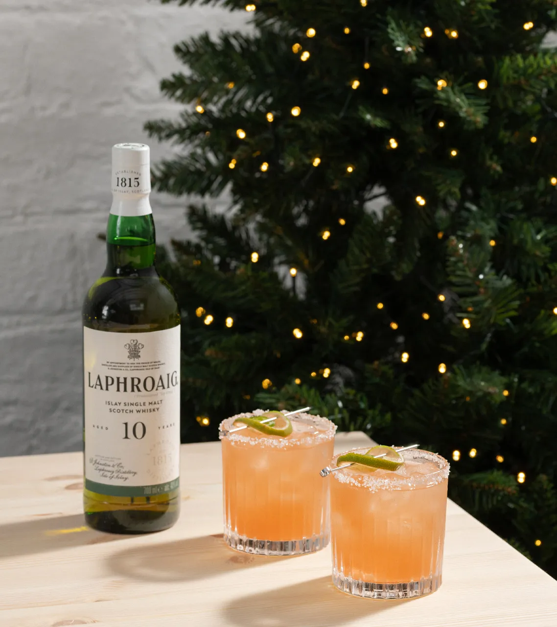 Laphroaig 10 Year Old Whisky next to two drams with Paloma whisky cocktail.