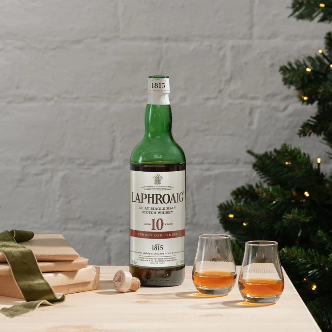 Sherry Oak Laphroaig bottle on a festive table with two glasses of drams