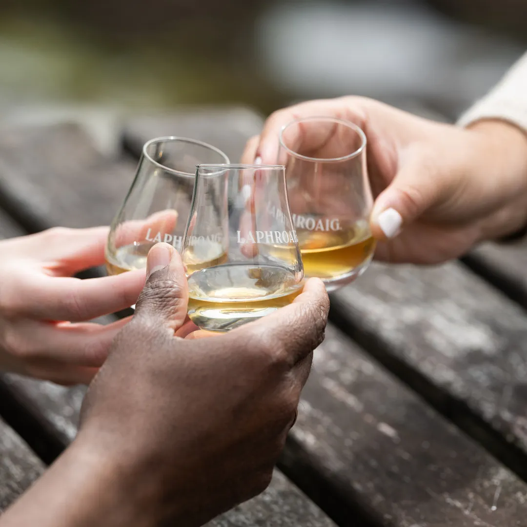 friends of laphroaig toasting with three drams