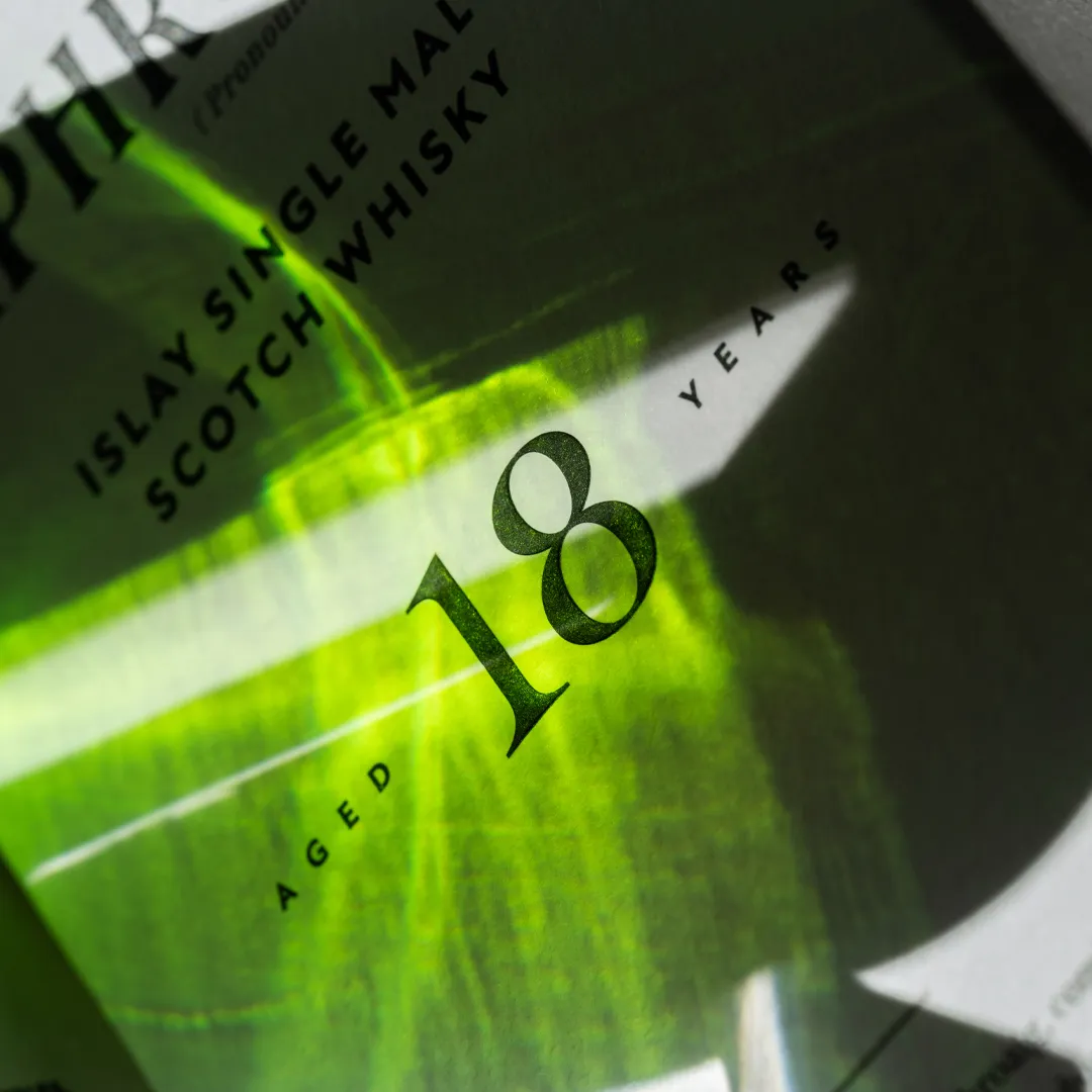 Laphroaig 18 Year Old Bottle label with green glass reflections
