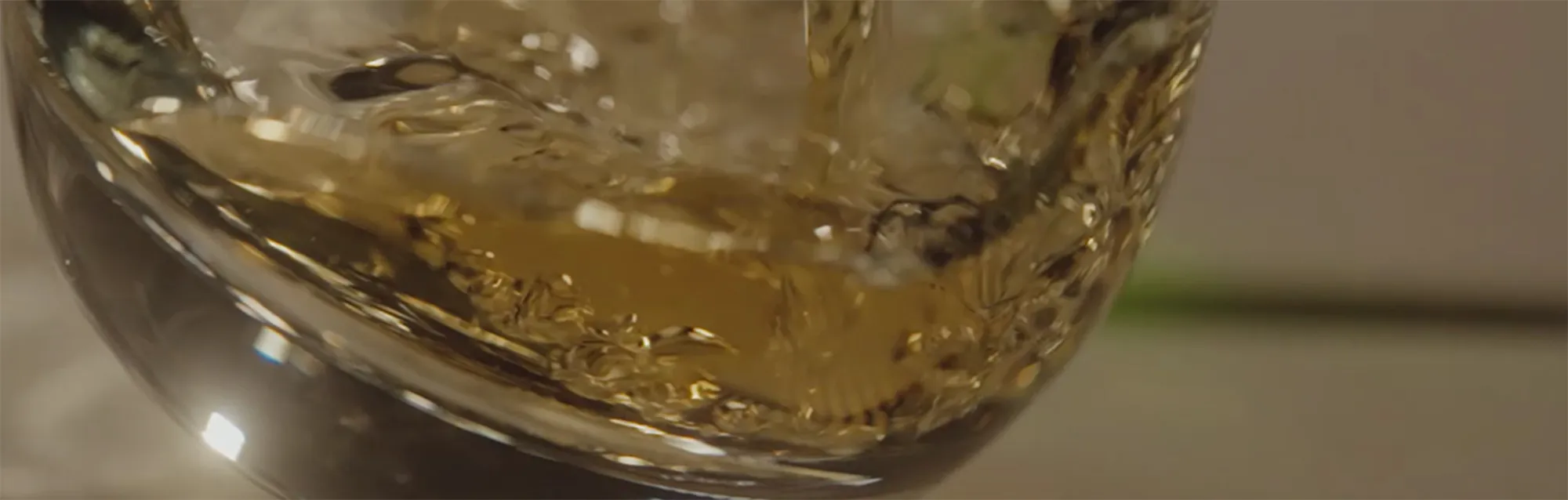 Whisky Liquid Swirling Glass Close Up Warm Tones Laphroaig