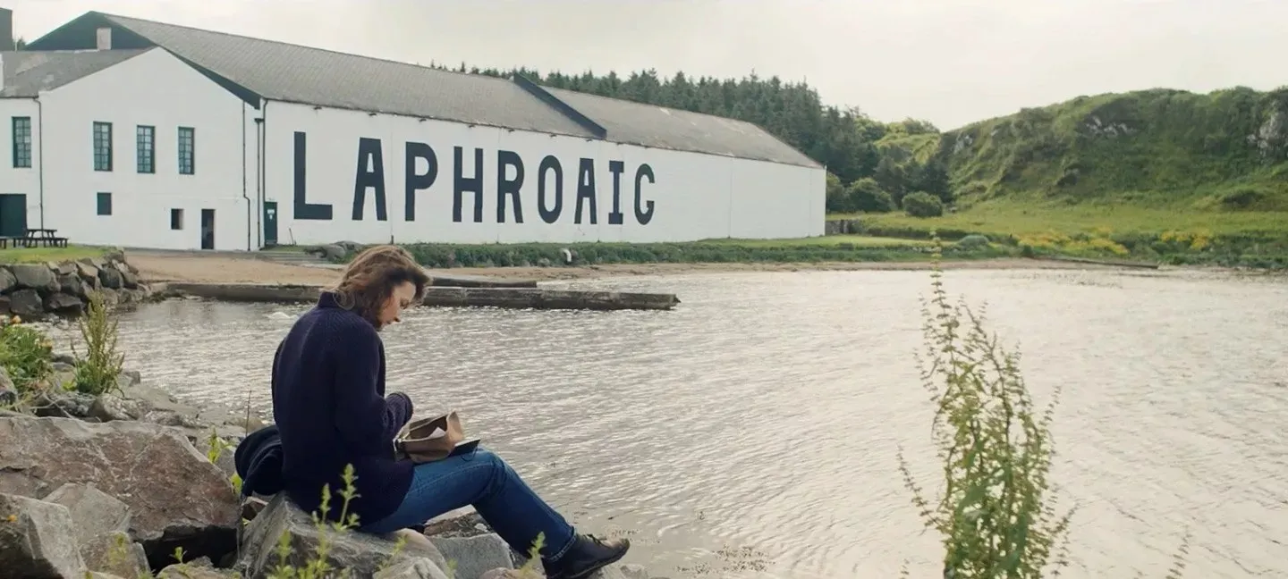 Visitor Seated Waterfront Distillery Building Quiet Moment Laphroaig