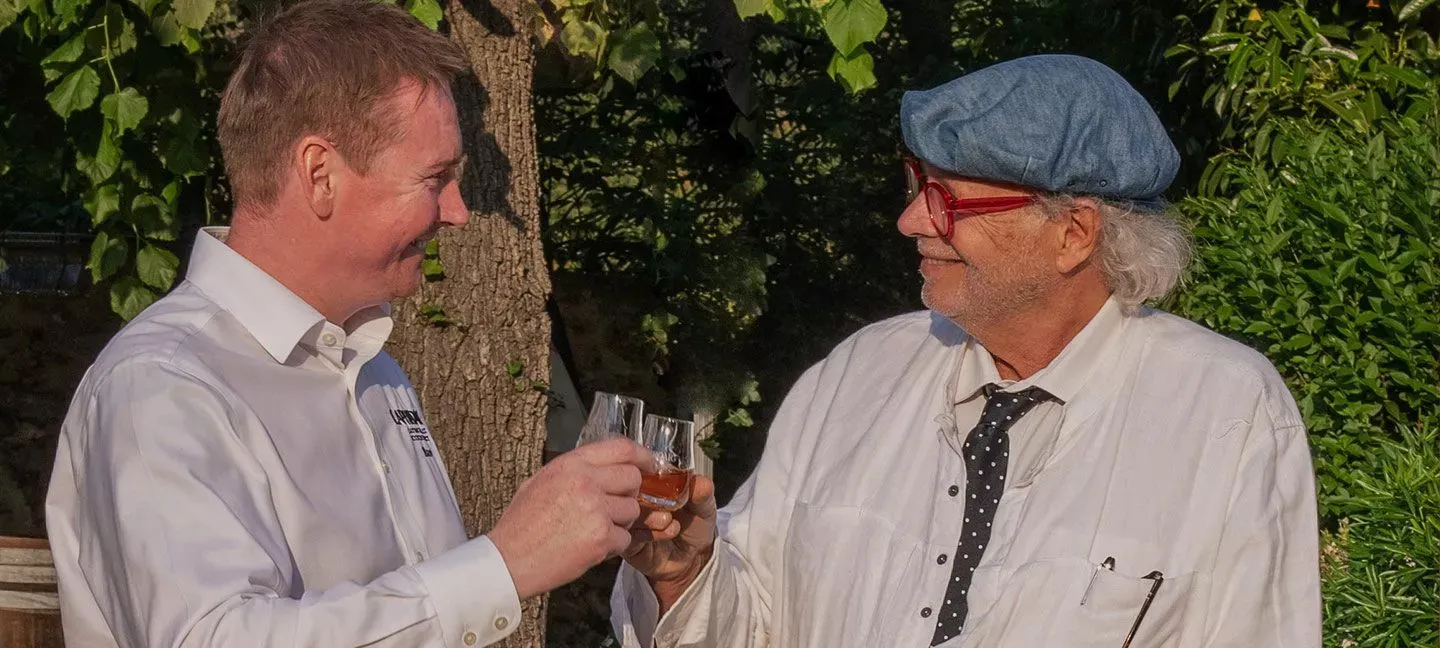 Two Men Toasting Whisky Glasses Outdoor Garden Experience Laphroaig