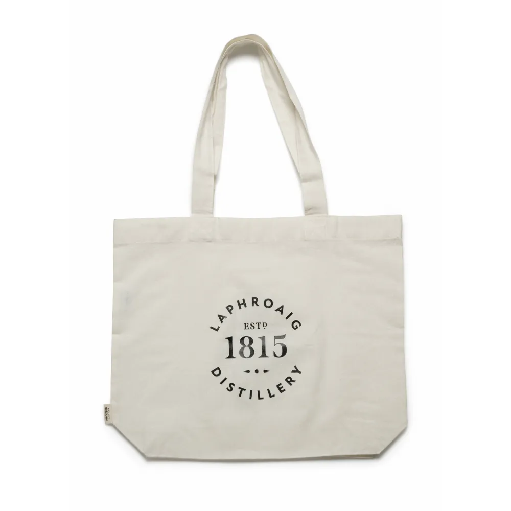 Cream canvas tote bag with long handles, featuring the black Laphroaig Distillery 1815 logo printed on the front.
